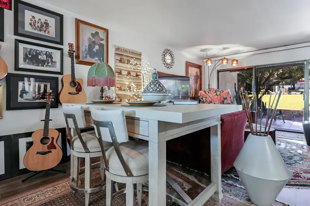 a dining hall with granite countertop a stove and a dining table with kitchen view