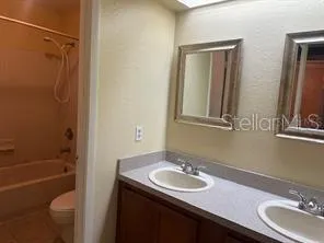 a bathroom with a sink toilet tub and shower