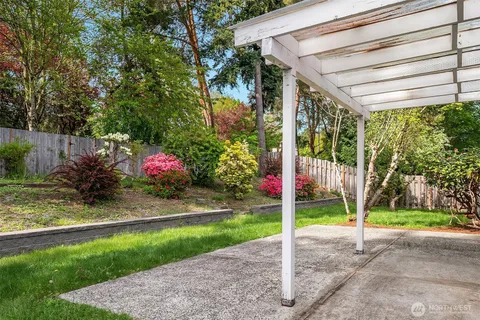 a view of a park with plants and a table and chairs