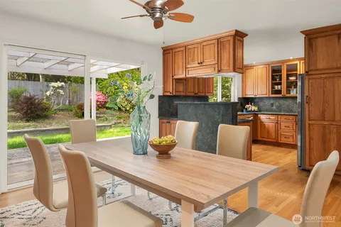 a view of a dining room with furniture a chandelier and wooden floor