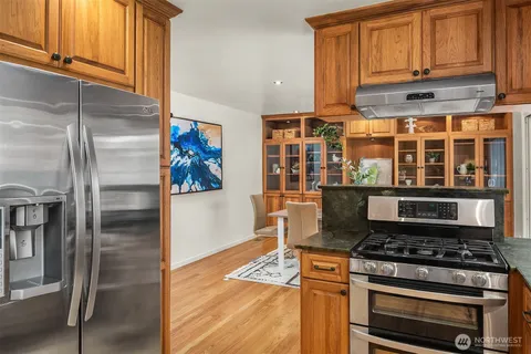 a stove top oven sitting inside of a kitchen