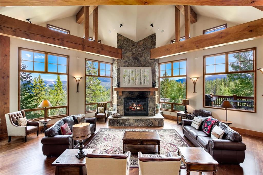 1050 4 O Clock Road Breckenridge, CO 80424 - Photo 2 of 35 a living room with furniture large window and fireplace