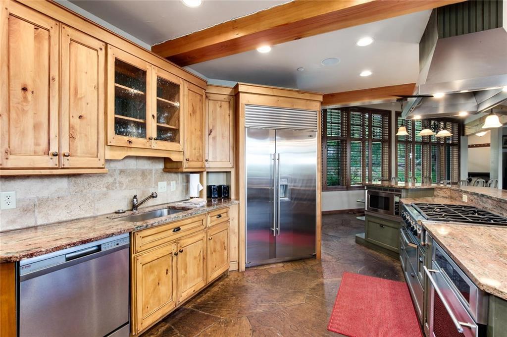 1050 4 O Clock Road Breckenridge, CO 80424 - Photo 11 of 35 a kitchen with stainless steel appliances granite countertop a stove a sink and a refrigerator