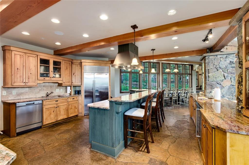 1050 4 O Clock Road Breckenridge, CO 80424 - Photo 12 of 35 a dining hall with stainless steel appliances granite countertop a stove a sink a dining table and chairs