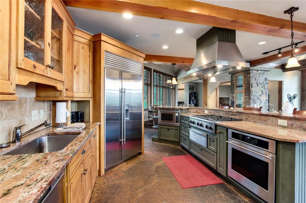 1050 4 O Clock Road Breckenridge, CO 80424 - Photo 3 of 35 a kitchen with stainless steel appliances granite countertop a sink a stove and a refrigerator