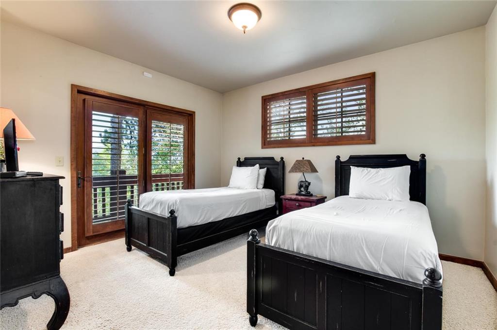 1050 4 O Clock Road Breckenridge, CO 80424 - Photo 24 of 35 a spacious bedroom with two beds and a window