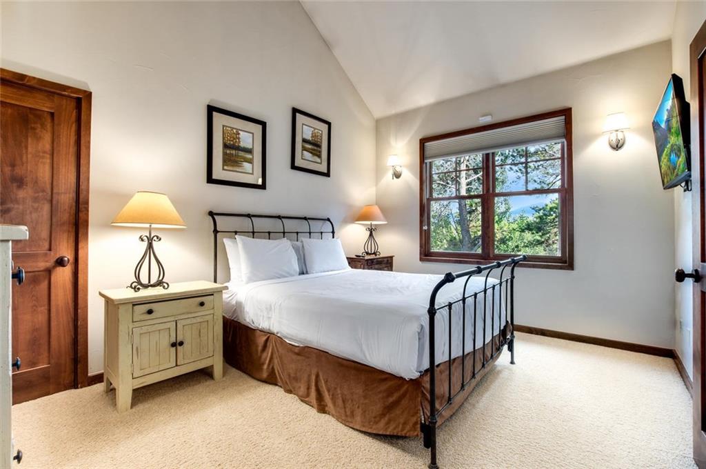 1050 4 O Clock Road Breckenridge, CO 80424 - Photo 26 of 35 a bedroom with a bed chandelier and a window
