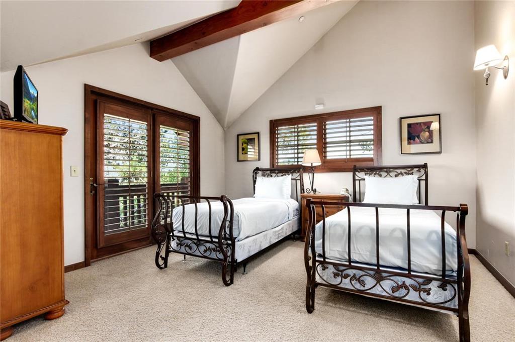 1050 4 O Clock Road Breckenridge, CO 80424 - Photo 27 of 35 a spacious bedroom with windows and bed
