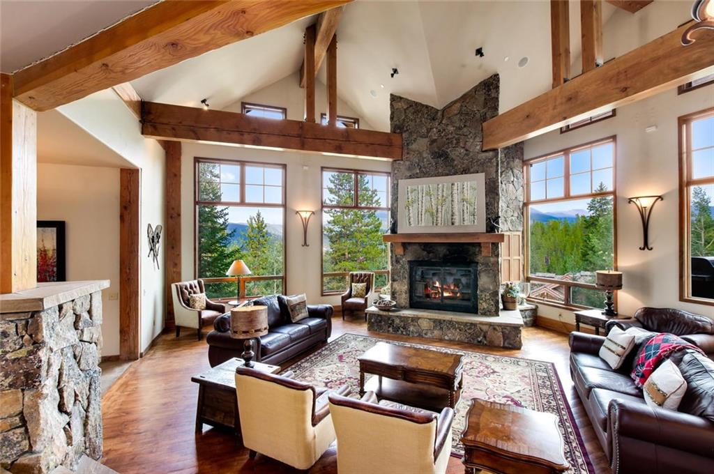 1050 4 O Clock Road Breckenridge, CO 80424 - Photo 7 of 35 a living room with furniture large window and a fireplace