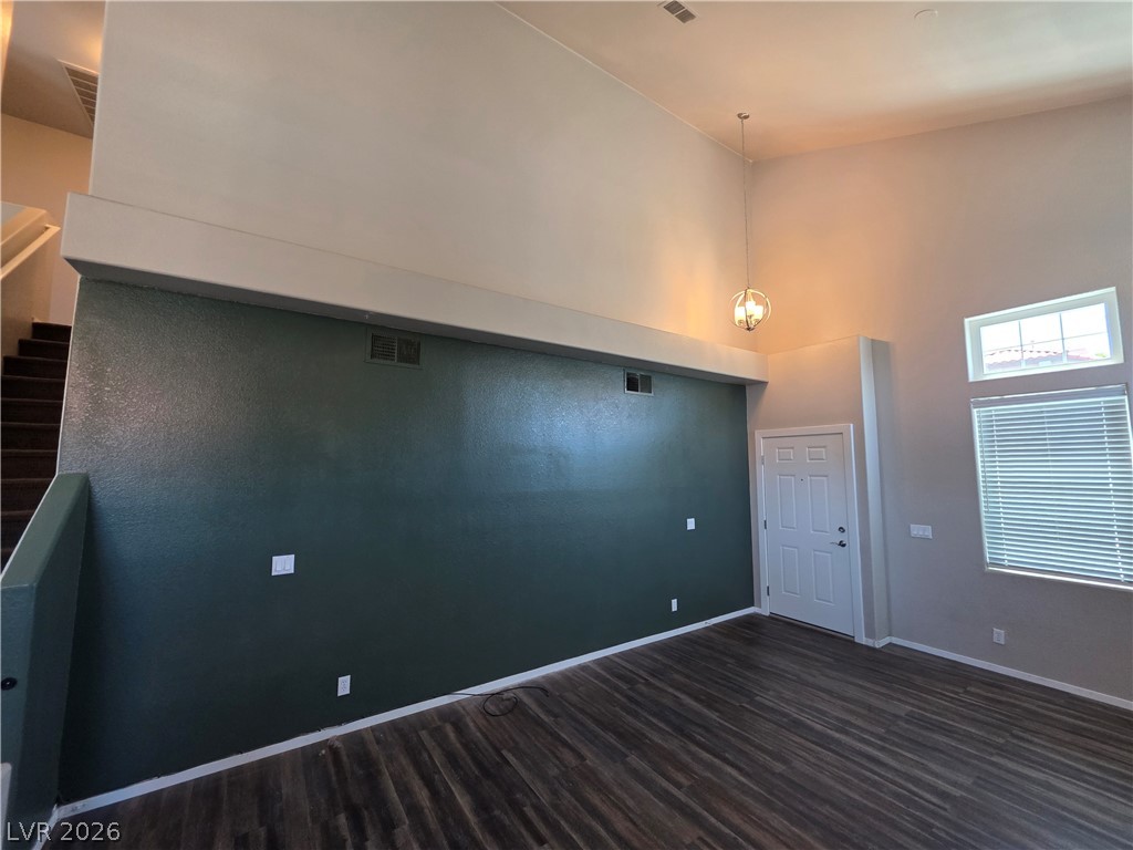 2275 Ramsgate Drive Henderson, NV 89074 - Photo 27 of 84 A spacious living room with dark wood flooring and high ceilings creates an inviting atmosphere.