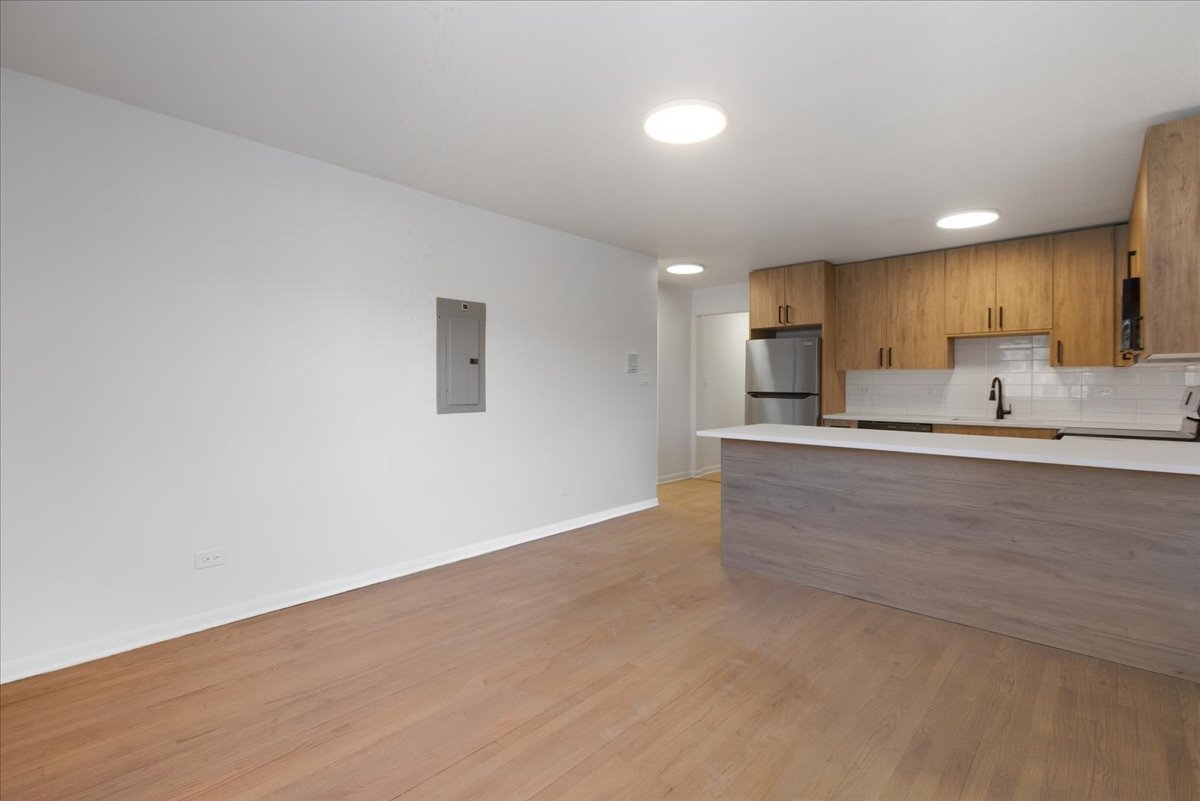 7357 North Winchester Avenue, Unit 2F Chicago, IL 60626 - Photo 5 of 12 a view of kitchen cabinets and stainless steel appliances