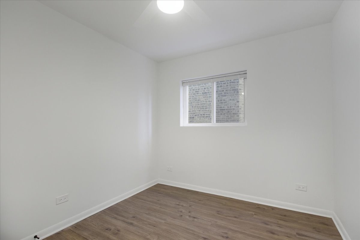 7357 North Winchester Avenue, Unit 2F Chicago, IL 60626 - Photo 9 of 12 a view of an empty room with wooden floor and a window
