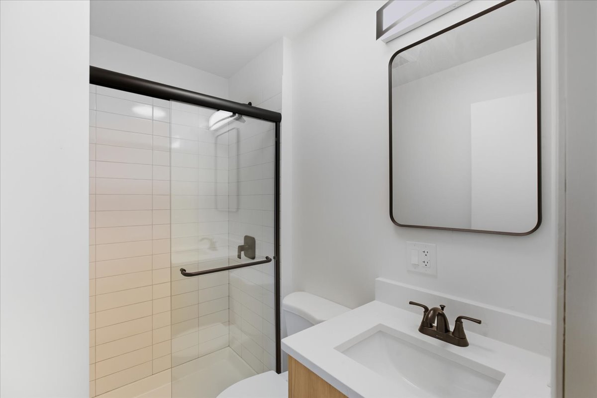 7357 North Winchester Avenue, Unit 2F Chicago, IL 60626 - Photo 10 of 12 a bathroom with a sink and a mirror