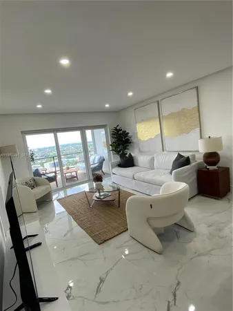 a living room with a flat screen tv and white walls