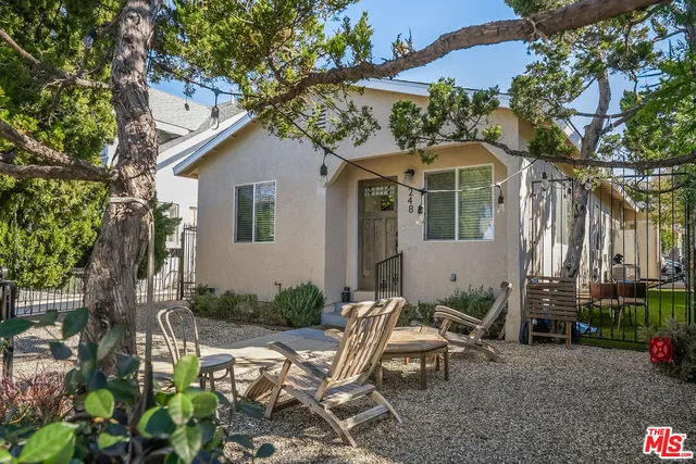 a view of a chair and table in backyard