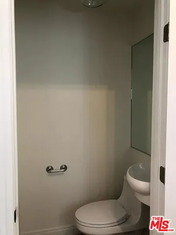 a white toilet and a shower curtain