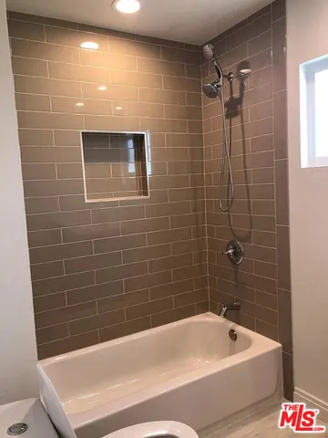 a bathroom with a bathtub and shower