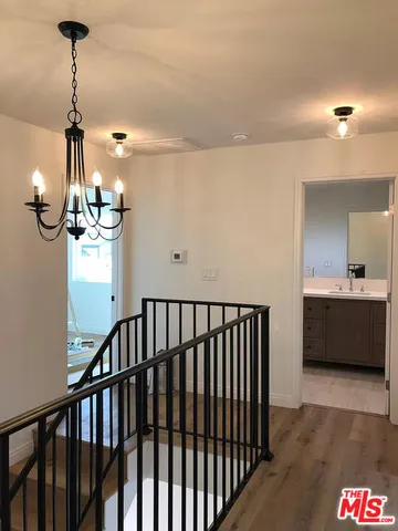 a view of a room with a window and wooden floor