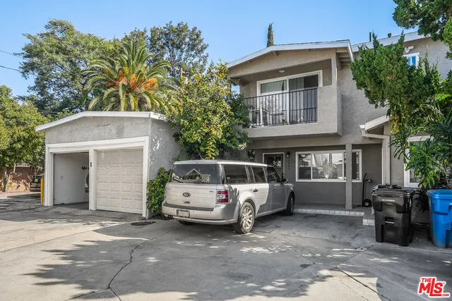 a car parked in front of white house