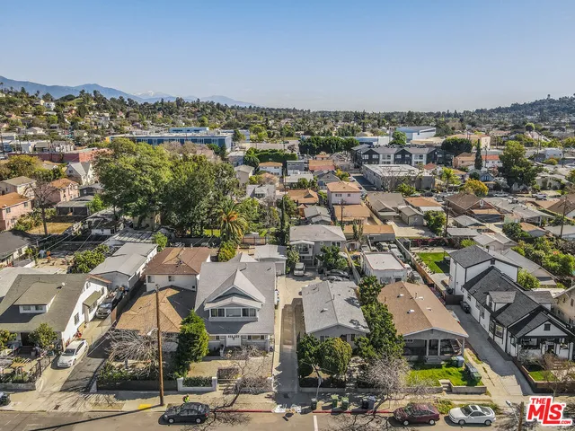 an aerial view of residential houses with outdoor space