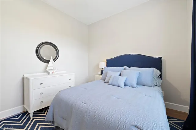 a bedroom with a bed and a chair