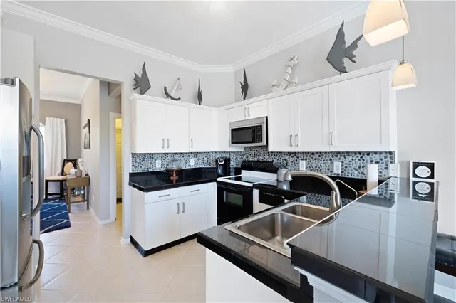 a kitchen with a sink a stove and cabinets