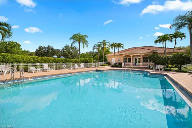 a view of swimming pool with outdoor seating and lake view