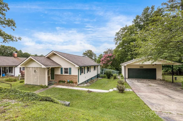 a front view of a house with a garden and yard