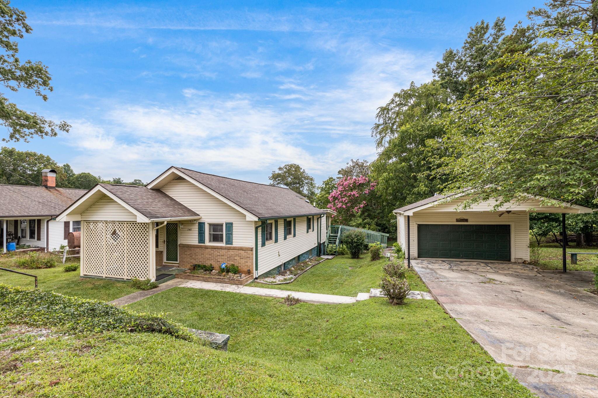 a front view of a house with a garden and yard