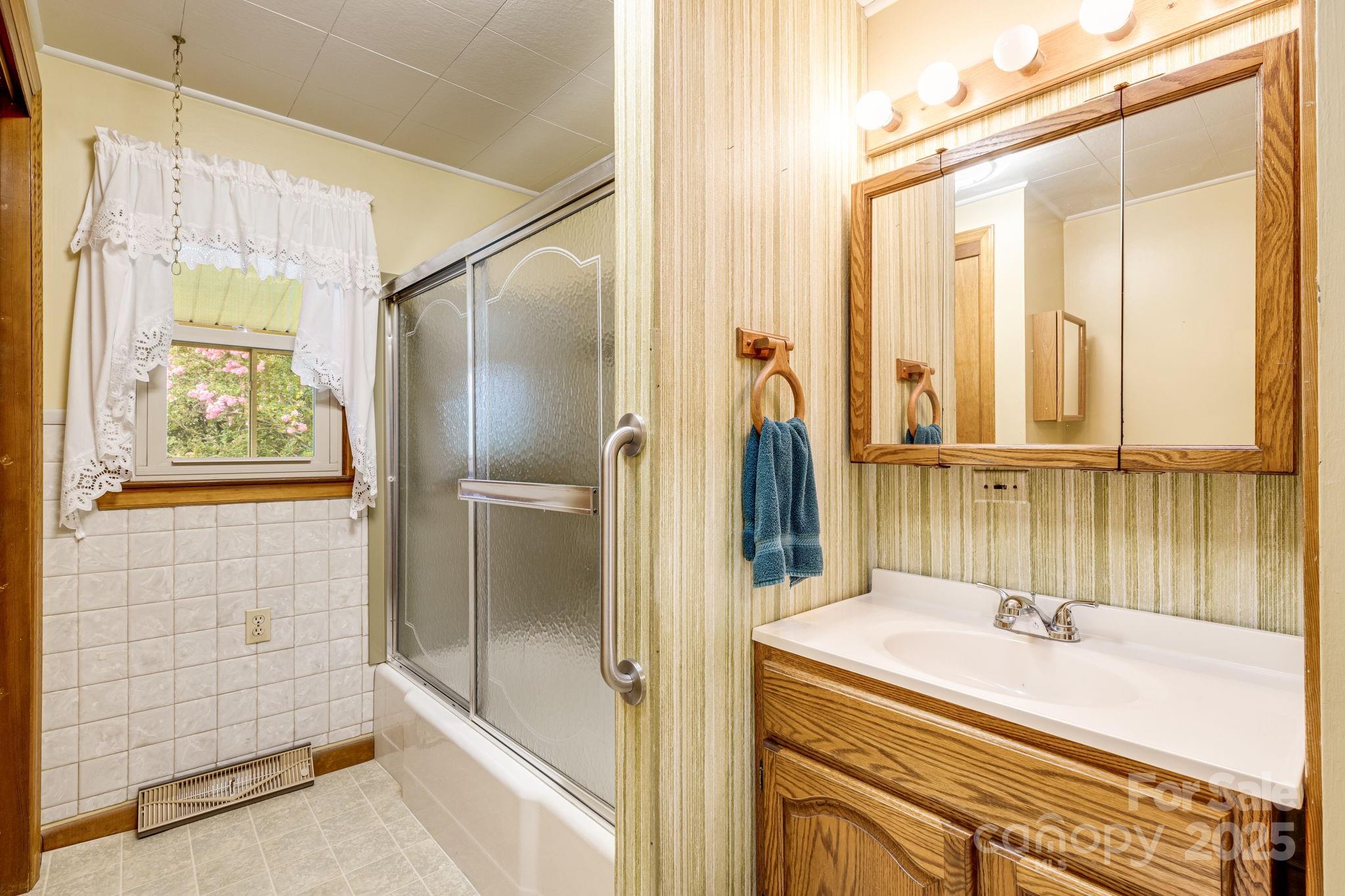 141 Macedonia Road Asheville, NC 28804 - Photo 17 of 33 a bathroom with a tub and a shower