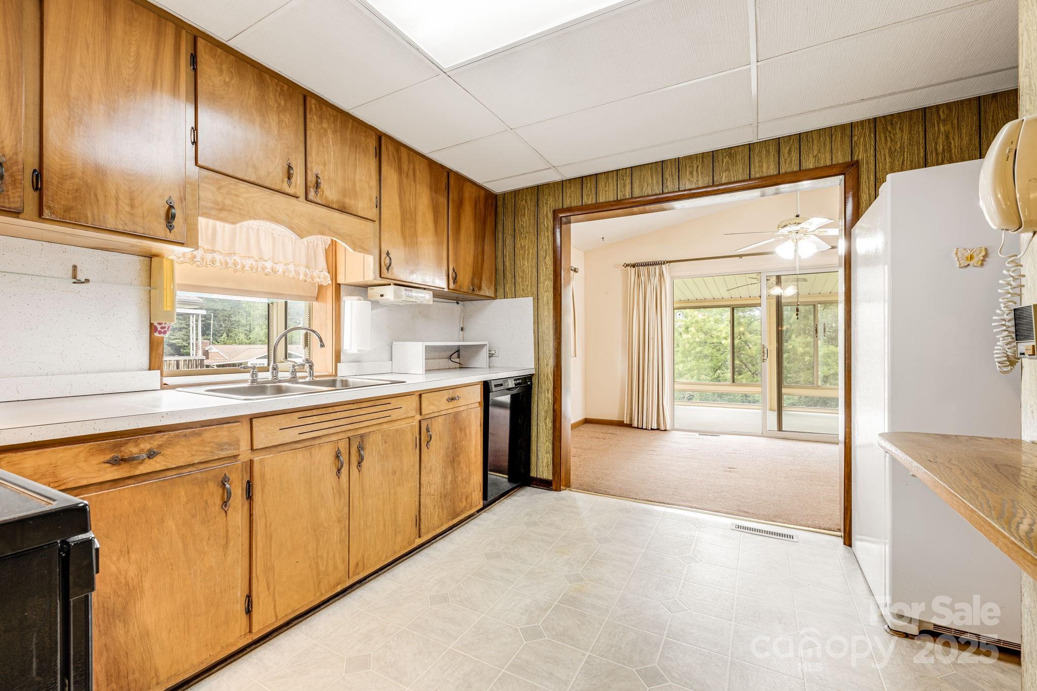141 Macedonia Road Asheville, NC 28804 - Photo 7 of 33 a open kitchen with stainless steel appliances granite countertop a refrigerator a sink dishwasher and a dining table next to a window
