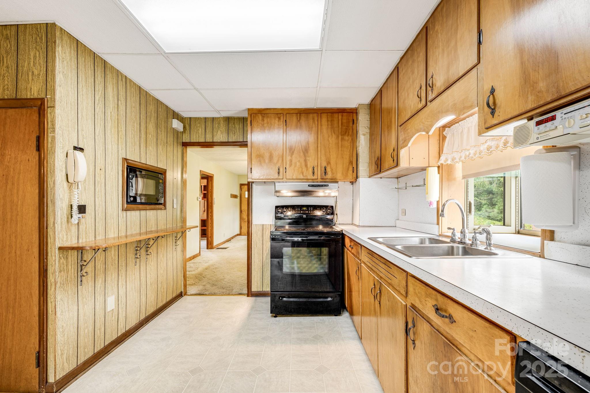 141 Macedonia Road Asheville, NC 28804 - Photo 8 of 33 a kitchen with stainless steel appliances granite countertop a stove a sink and a refrigerator