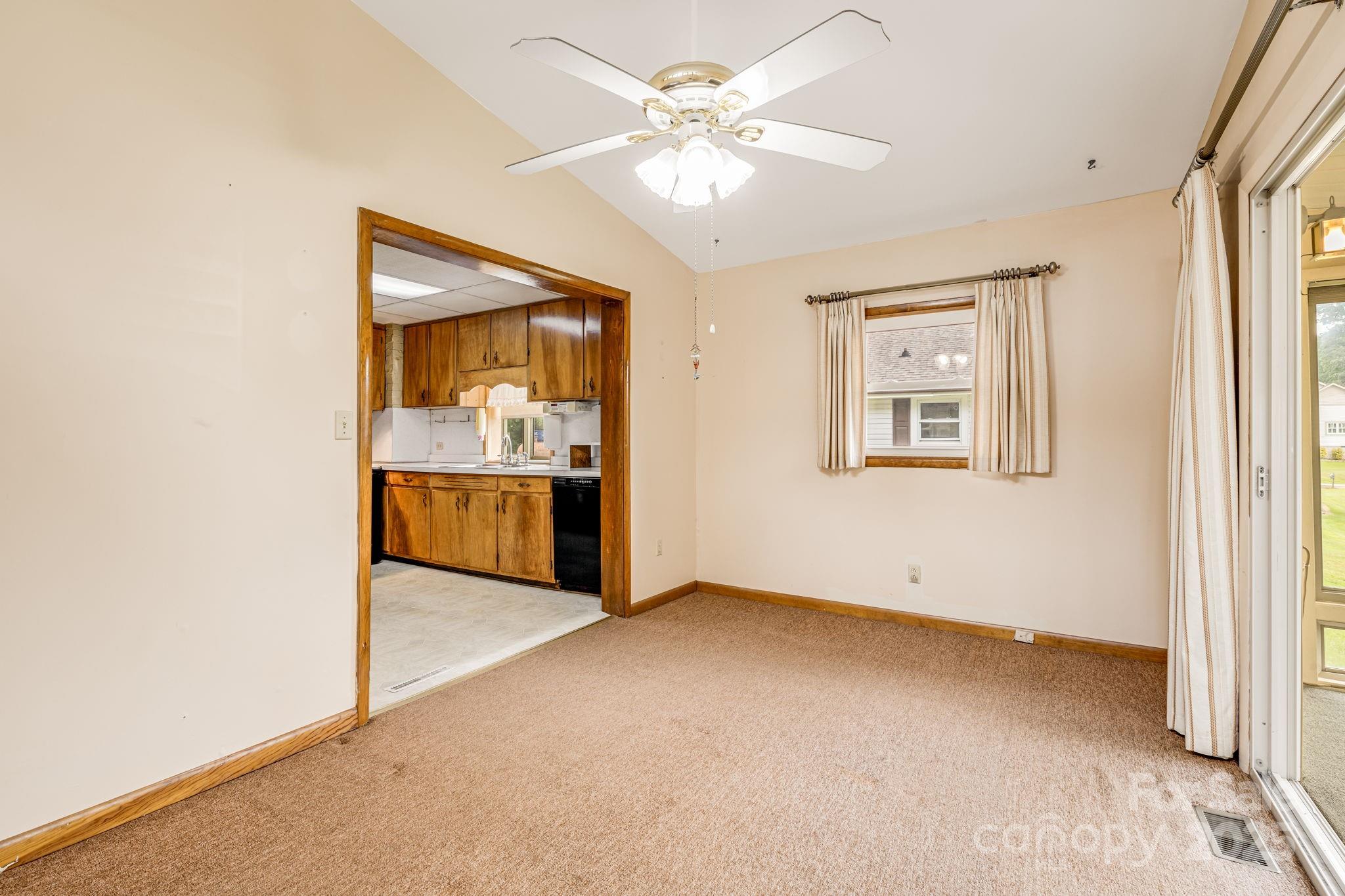 141 Macedonia Road Asheville, NC 28804 - Photo 10 of 33 an empty room with windows and ceiling fan