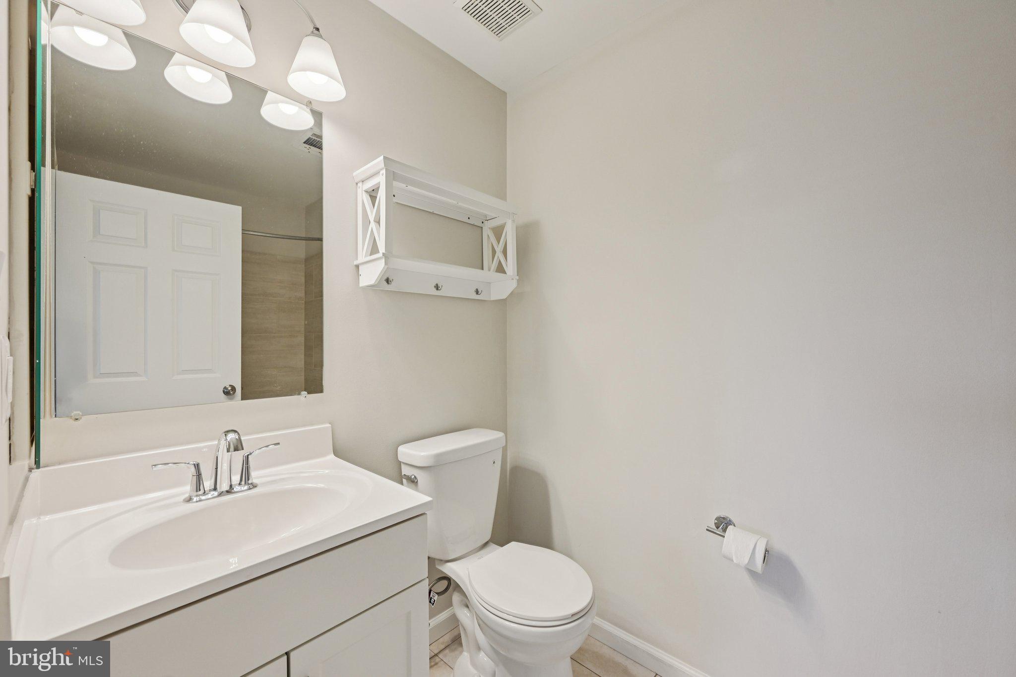2104 Whitehall Road, Unit 2B Frederick, MD 21702 - Photo 24 of 37 a bathroom with a sink a toilet and mirror
