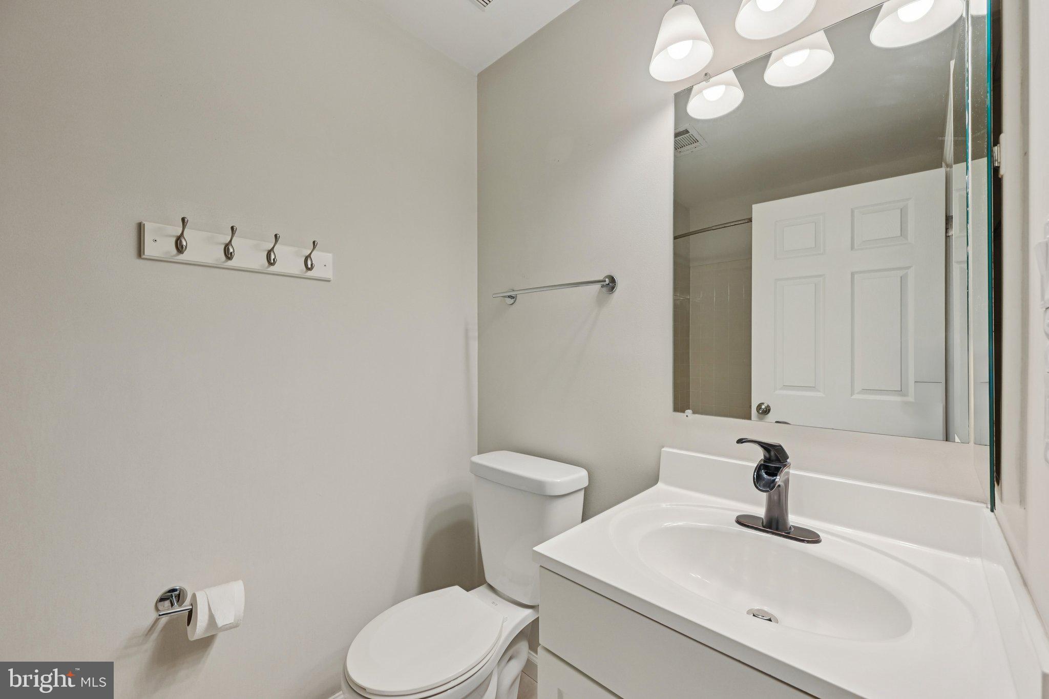 2104 Whitehall Road, Unit 2B Frederick, MD 21702 - Photo 29 of 37 a bathroom with a sink a toilet and a mirror