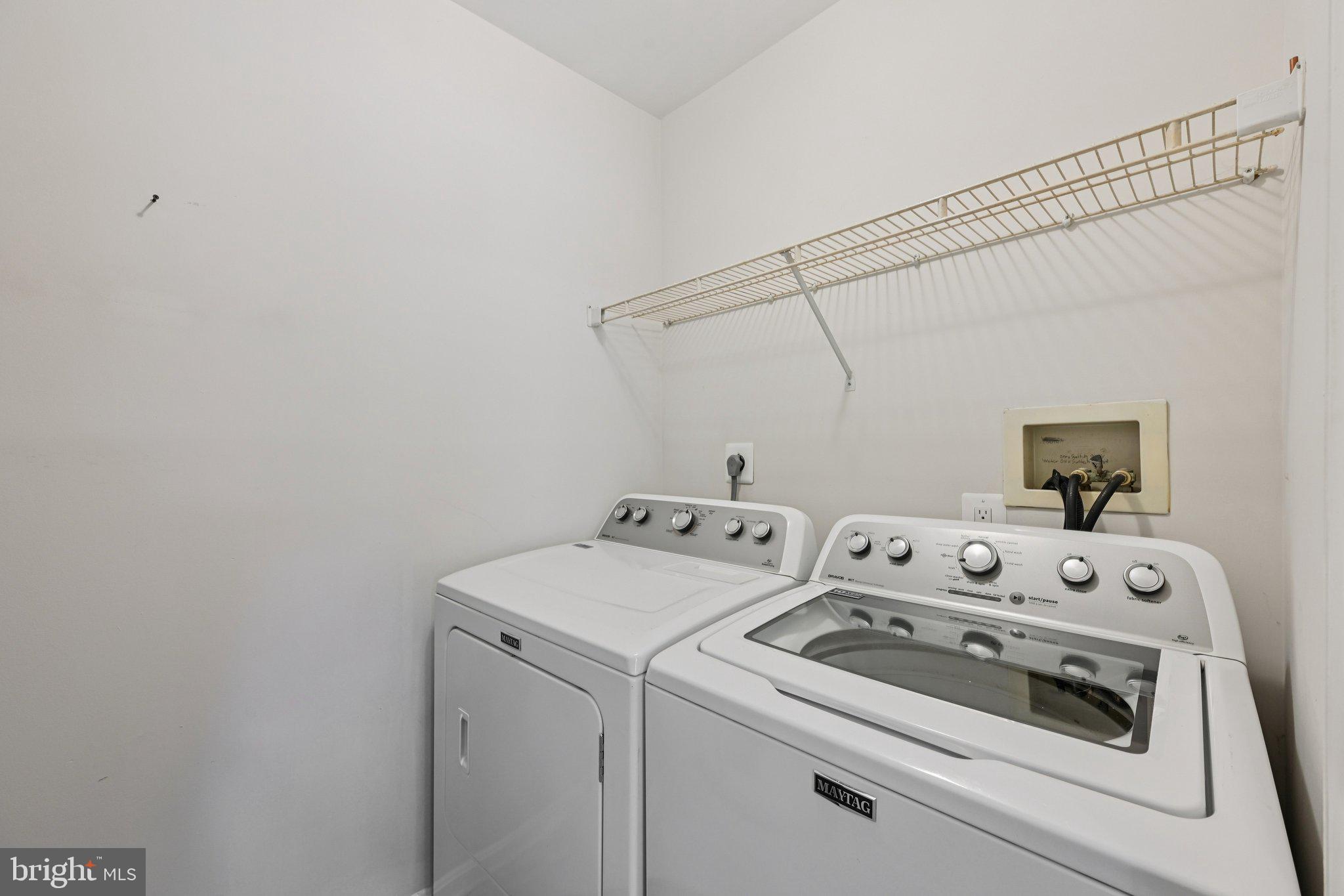 2104 Whitehall Road, Unit 2B Frederick, MD 21702 - Photo 31 of 37 a view of washer and dryer with bathroom in the background
