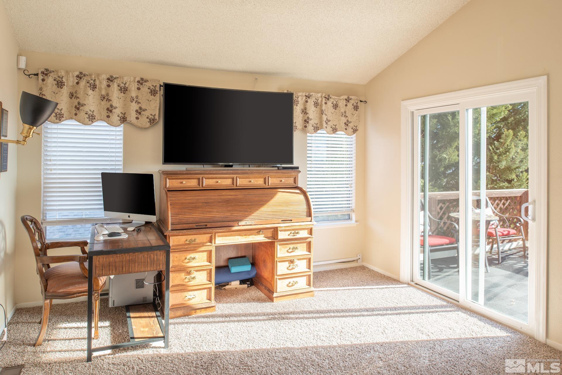 3836 Bexley Square Reno, NV 89503 - Photo 15 of 38 a living room with a flat screen tv and a fireplace