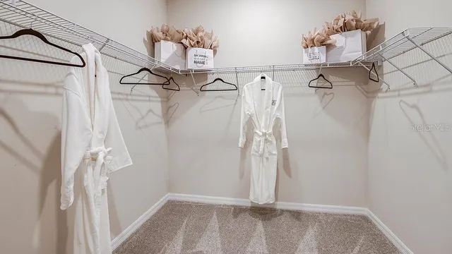 a view of a hallway with wooden shelves