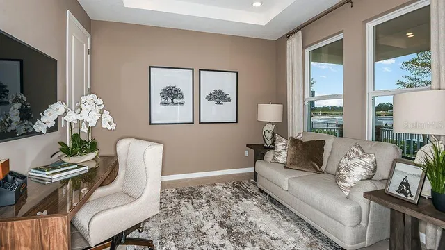 a kitchen with stainless steel appliances granite countertop a refrigerator a sink a stove and chairs