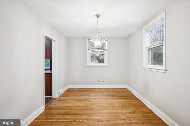 a view of a room with wooden floor and windows