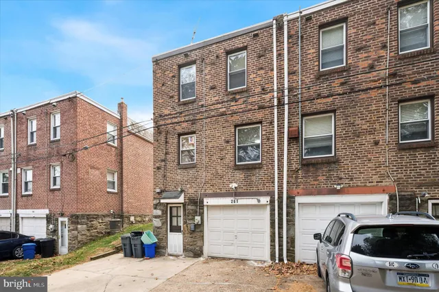 a front view of a building with parking space