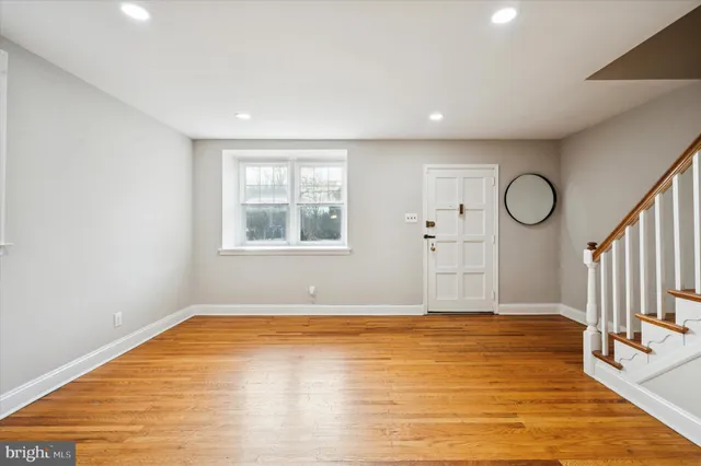 a view of a room with wooden floor and window