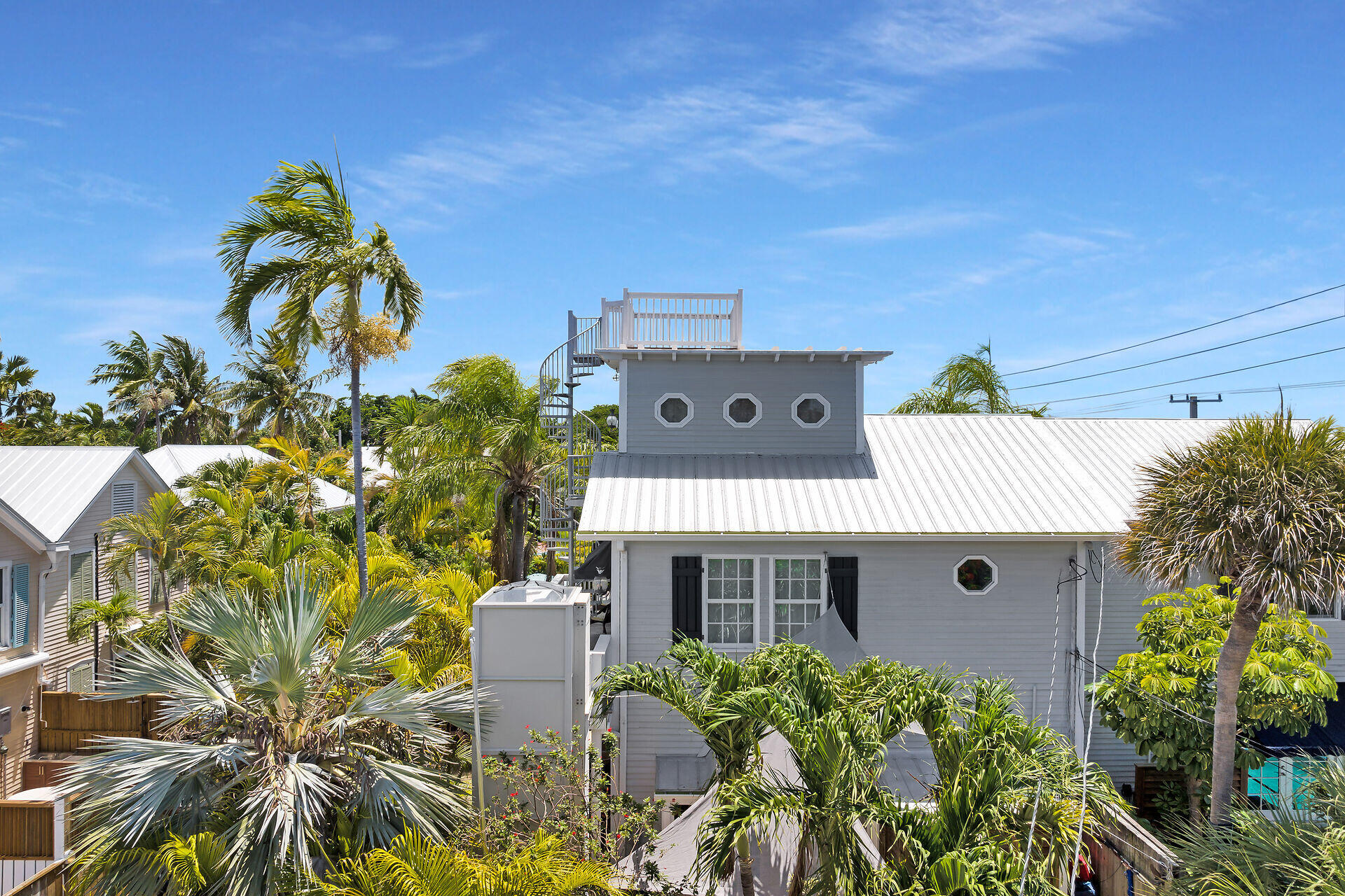 1001 United Street, Unit B Key West, FL 33040 - Photo 12 of 48 a picture of a building with a lot of plants and flowers