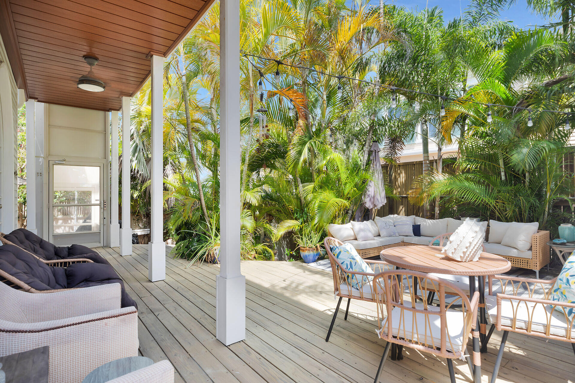1001 United Street, Unit B Key West, FL 33040 - Photo 43 of 48 a view of a patio with a dining table and chairs with wooden floor and fence