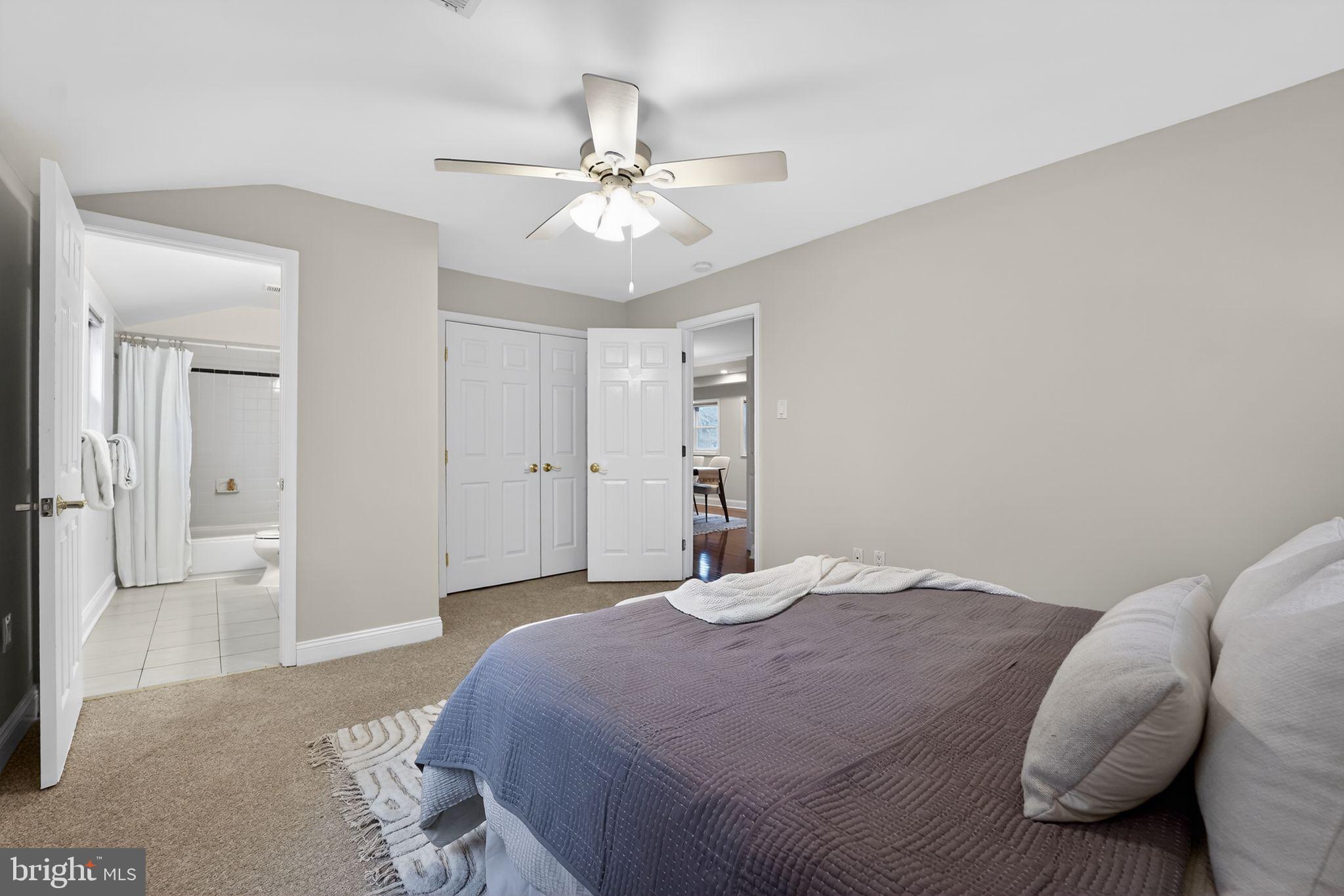 23711 Slidell Road Clarksburg, MD 20871 - Photo 13 of 31 a bedroom with a large bed and a chandelier