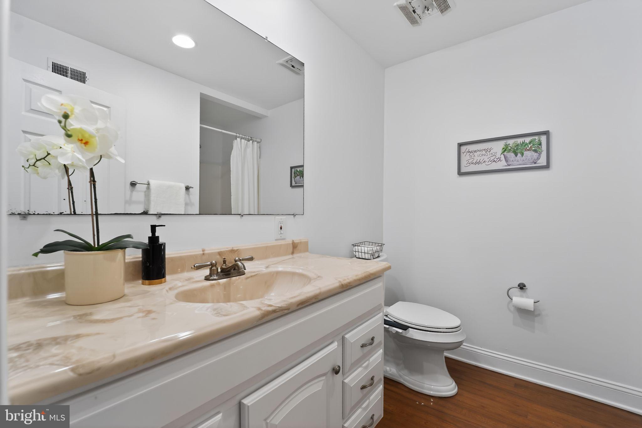 23711 Slidell Road Clarksburg, MD 20871 - Photo 20 of 31 a bathroom with a granite countertop toilet sink and mirror
