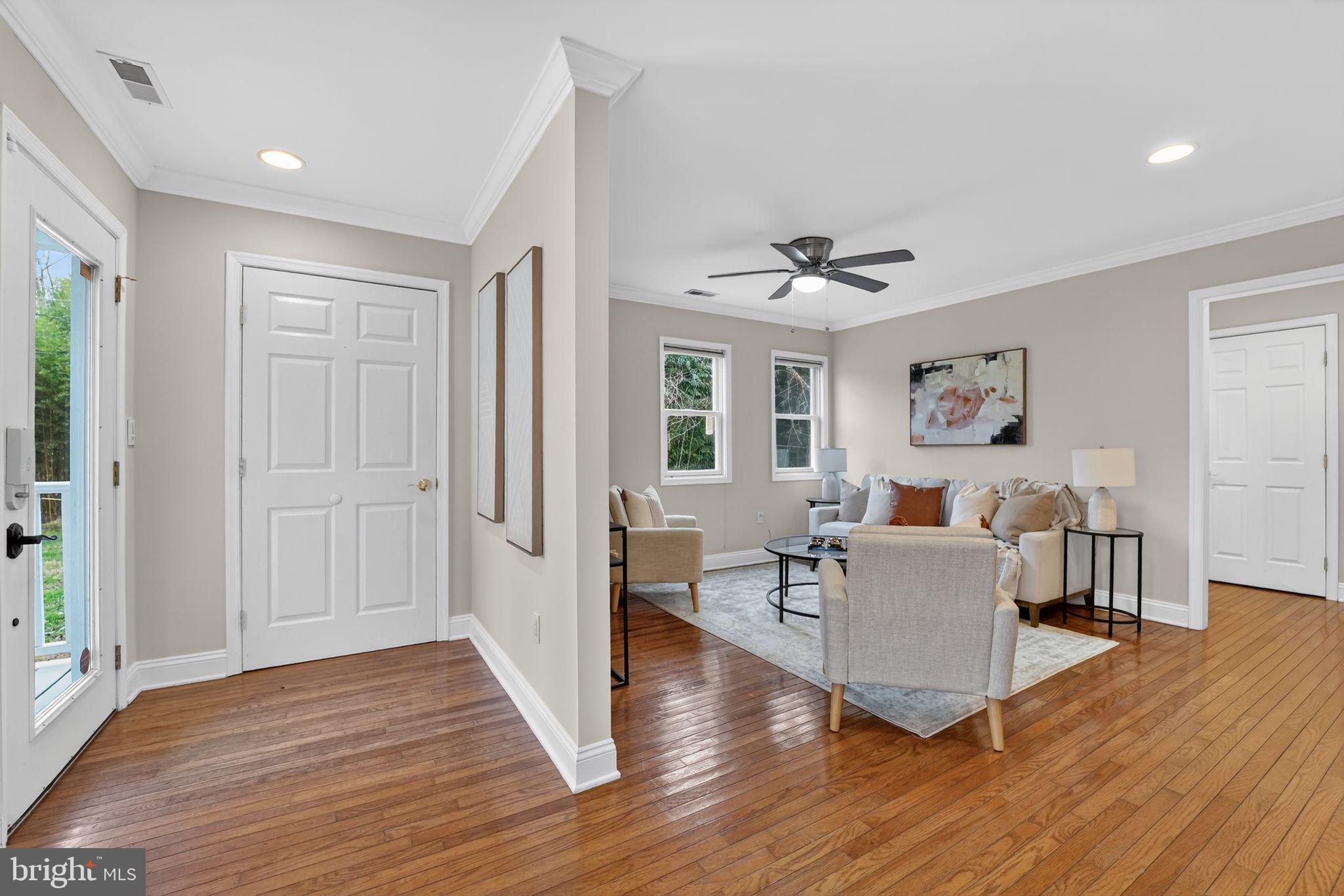 23711 Slidell Road Clarksburg, MD 20871 - Photo 2 of 31 a living room with furniture and a wooden floor