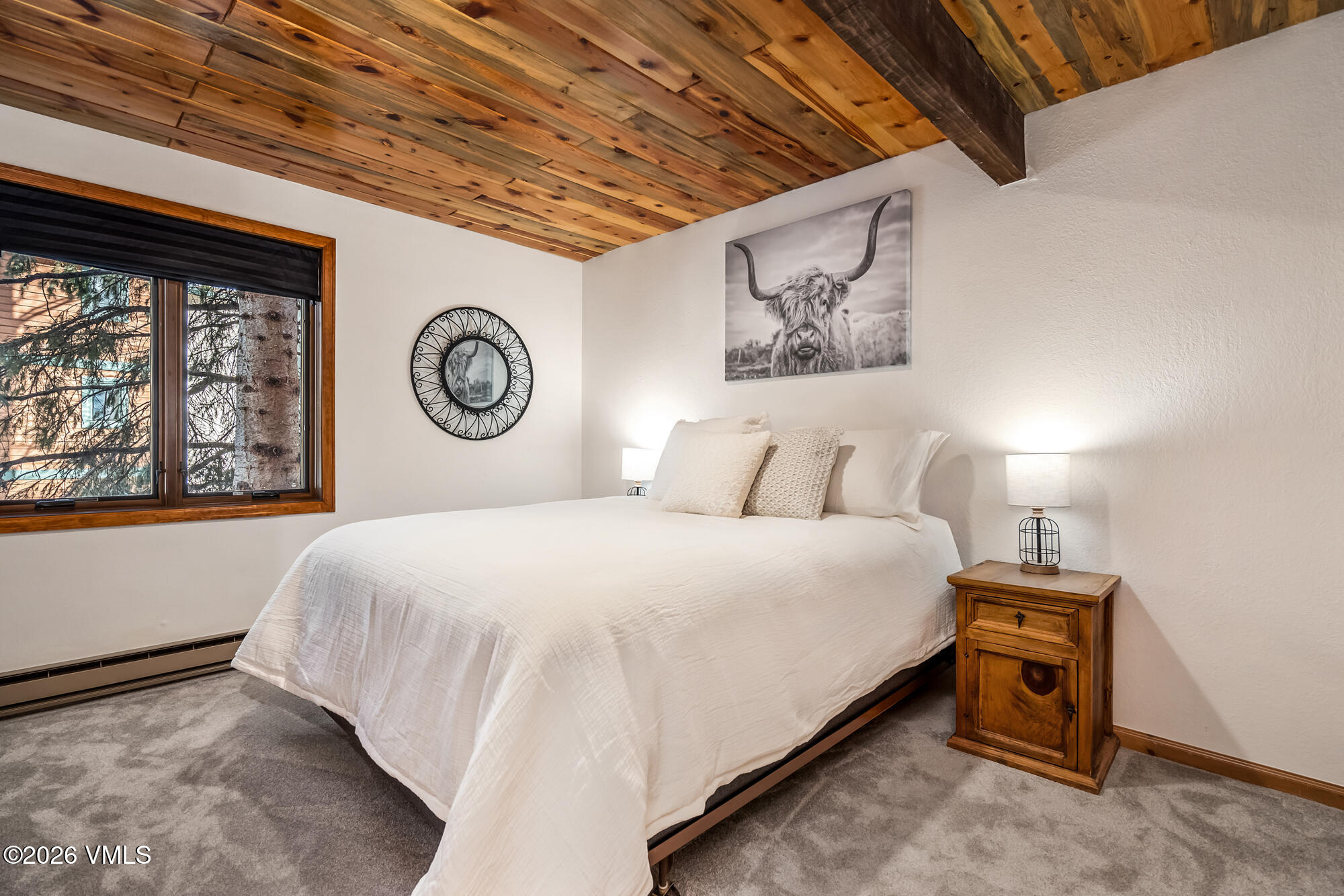 4470 Timber Falls Court, Unit 1405 Vail, CO 81657 - Photo 16 of 35 a bedroom with a bed and a large window