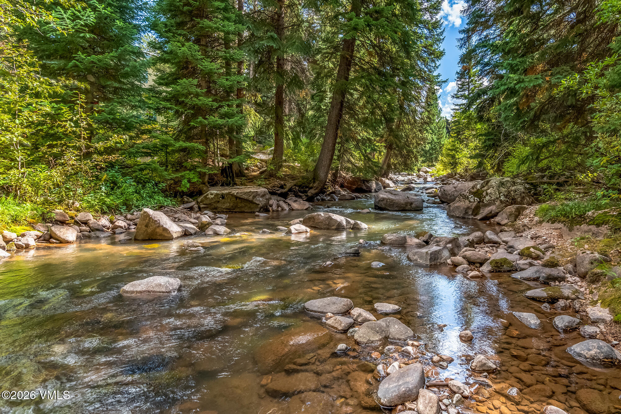 4470 Timber Falls Court, Unit 1405 Vail, CO 81657 - Photo 31 of 35 a backyard of a house with lots of green space