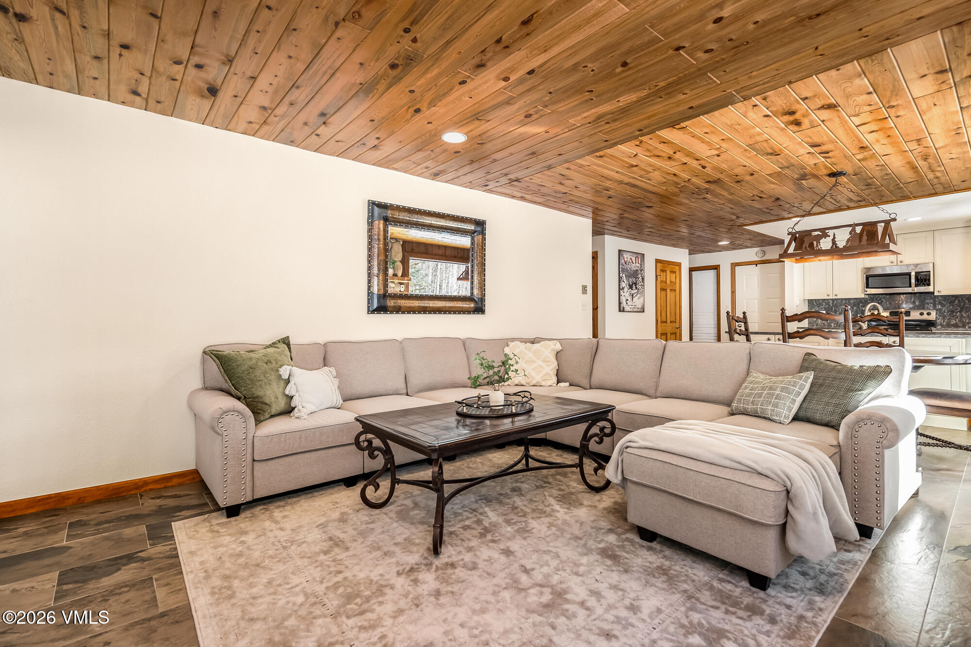 4470 Timber Falls Court, Unit 1405 Vail, CO 81657 - Photo 6 of 35 a living room with furniture and a wooden floor